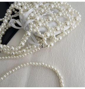 Detailed close-up of handmade pearl weave texture and satin drawstring lining