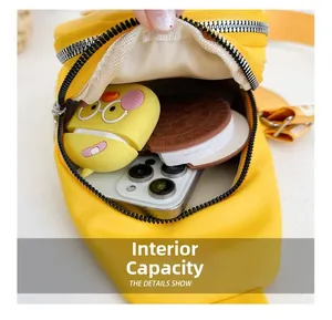 Internal capacity of yellow PU mini chest bag showing phone and accessories storage