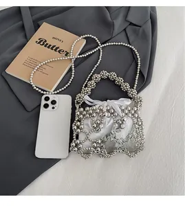 Detail of silver beaded mesh bag with white satin drawstring inner pouch and long strap