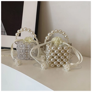 Detail of beaded mini bags with large pearls and drawstring satin inner lining