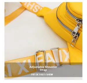 Detail of adjustable woven strap with letter print and dual zipper on yellow kids chest bag