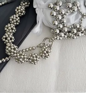 Macro shot of detachable silver metal spring hook and beaded strap for kids handbag