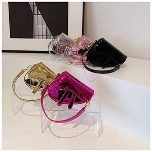 Close-up of mini metallic saddle bags in various colors with golden hardware hooks