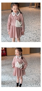 Close-up of girls floral pink dress with white lace collar and pearl crossbody bag details