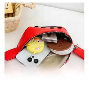 Detail view of red leather kids fanny pack interior showing spacious storage capacity