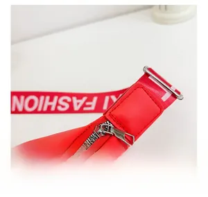 Detail of red kids waist bag with silver zipper and FASHION printed nylon strap