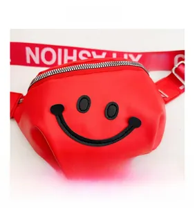 Detailed view of red kids waist bag featuring embroidered smiley and NOISHSAF strap
