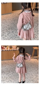 Detailed view of kids cherry print pink dress with a woven pearl crossbody bag
