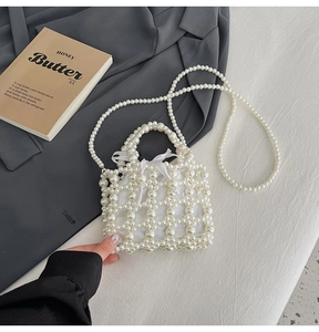 Detail of white pearl woven handbag featuring satin bow and drawstring liner pouch