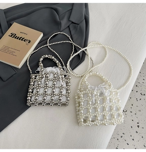 Detail of beaded woven handbag with pearl handles and satin drawstring lining