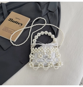 Detail of handmade faux pearl shoulder bag with drawstring satin lining and chain