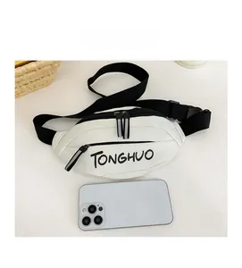White PU leather kids chest bag with TONGHUO logo and phone for size comparison