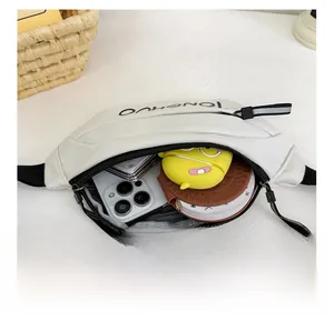 Detailed interior view of a white kids waist bag showing storage for phone and accessories