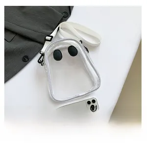 Ghost-shaped transparent PVC crossbody bag with woven strap and leather eyes detail