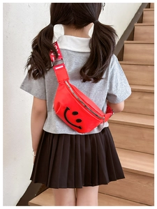 Close-up of red children waist bag with smile face and LOVE letter strap