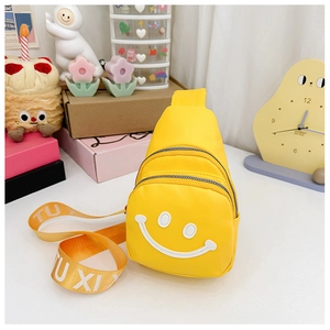 Detail of yellow canvas kids chest bag with smiley face print and woven letter strap