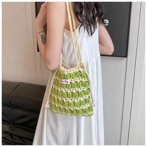 Détail d'un sac à bandoulière en tricot rayé vert et crème avec étiquette Sweet Cherry