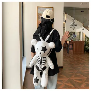 Creative teddy bear backpack with skeleton print and star patches worn by a model