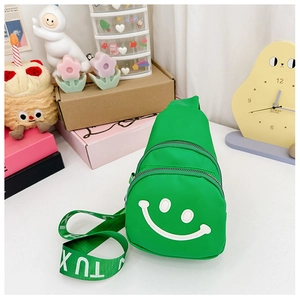 Close-up of green kids chest bag featuring a white smiley face and stylish strap