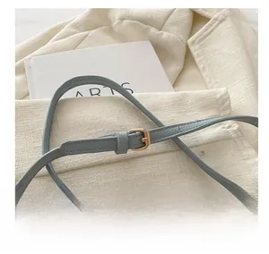 Detail of adjustable light blue leather strap with premium gold metal buckle for kids bag