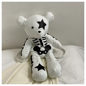 Detail of cute bear backpack featuring gothic bone print and star eye on white leather