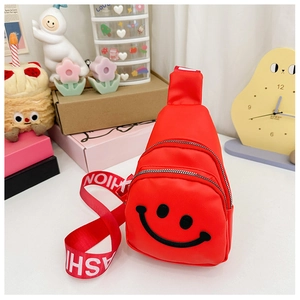 Close-up of vibrant red kids chest bag with smiley face and FASHION lettered strap