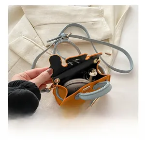 Interior view showing capacity for small items in orange leather girls cross body bag