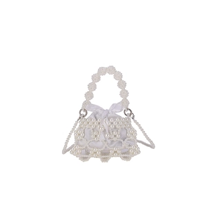 Hollow pearl beaded shoulder bag with white drawstring liner and crossbody strap