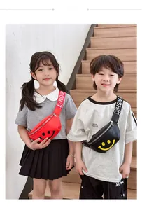 Detailed view of kids' red and black smiley face waist bags with fashion lettered straps