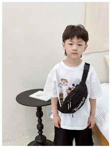 Detail of a black nylon kids chest bag with white TONGHUO lettering and adjustable strap