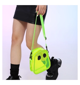 Close-up of neon yellow transparent jelly bag featuring cartoon eyes and nylon strap