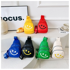 Detailed view of kids colorful mini smiley face sling bags in six vibrant colors with wide straps