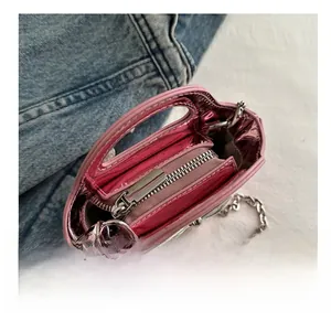 Detail view of pink laser metallic handbag showing smooth silver zipper and inner pocket