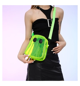 Neon green transparent jelly crossbody bag with fun eye detail on a fashion model