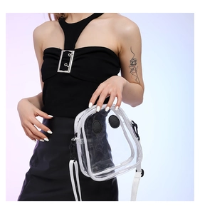 Detail of transparent PVC crossbody bag with cute eye design and white strap