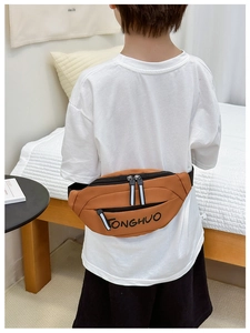 Rear view of child wearing a brown canvas waist bag with adjustable black strap
