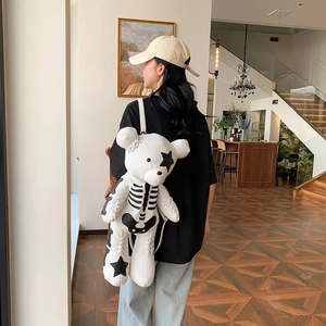 Cute white teddy bear backpack with black stitching and star patches for kids