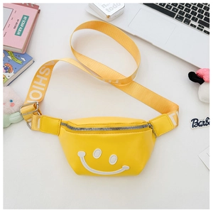 Detail of yellow nylon kids waist bag featuring smiley face and white FASHION strap
