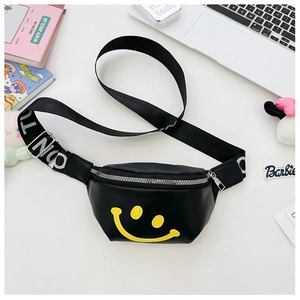 Detail of a black fanny pack for kids featuring a yellow smiley face and branded strap