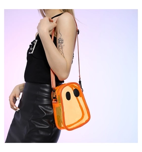 Detail of orange transparent PVC crossbody bag with minimalist ghost face design