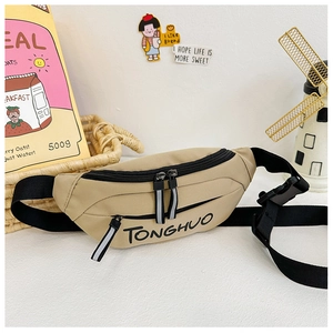 Close-up of khaki canvas kids chest bag featuring letter print and adjustable black strap