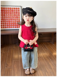 Girl's red striped tank top and wide-leg grey pants paired with a mini red crossbody bag
