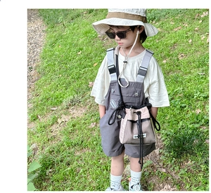 Close-up of children's outdoor drawstring crossbody bag with contrast paneling design
