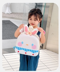 Detail of cute hardshell rabbit backpack with cartoon character and pink ears for kids