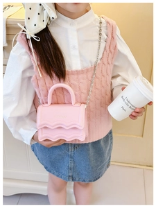 Detailed view of pink mini crossbody bag with wavy flap and silver chain for girls