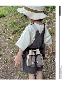 Close-up of kids drawstring crossbody bag featuring khaki and black mesh materials
