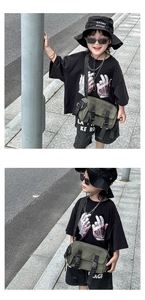 Detail of army green canvas kids messenger bag featuring dual buckle closure and streetwear style