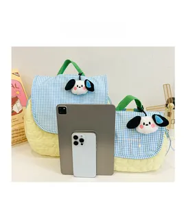 Size comparison of blue checkered children backpacks with plush dog charms and iPad