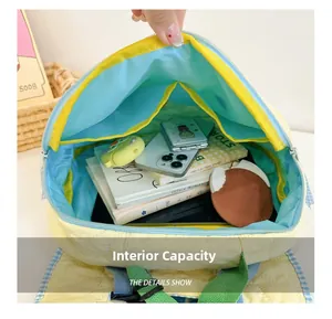 Detail view of the yellow quilted backpack interior showing large capacity and blue lining