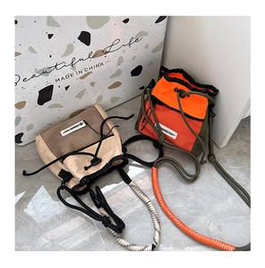 Detail of trendy nylon drawstring crossbody bags with woven rope straps for boys